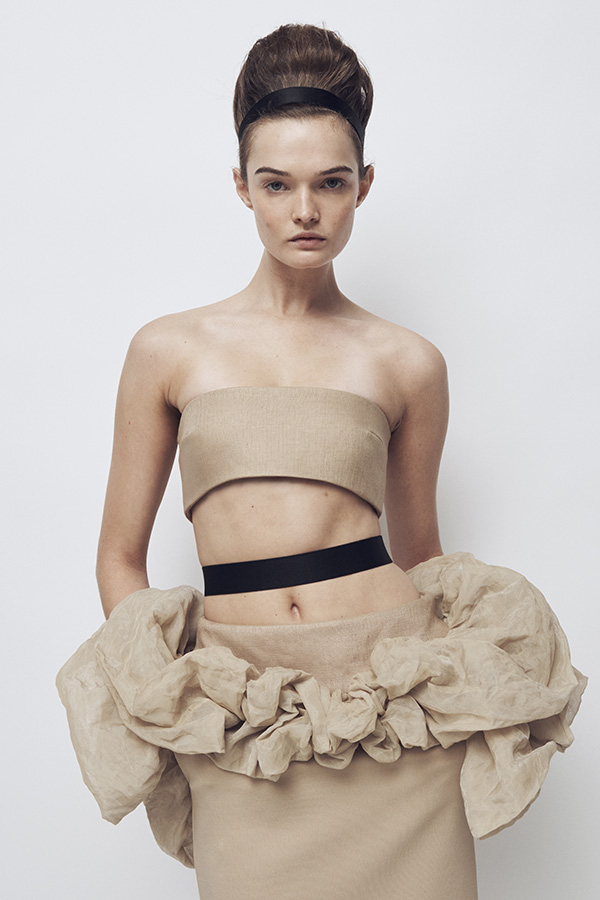 Max Mara Spring/Summer 2026 Fashion Show - Model with Look with Bandeau Top and beige Skirt with matching ruffles.